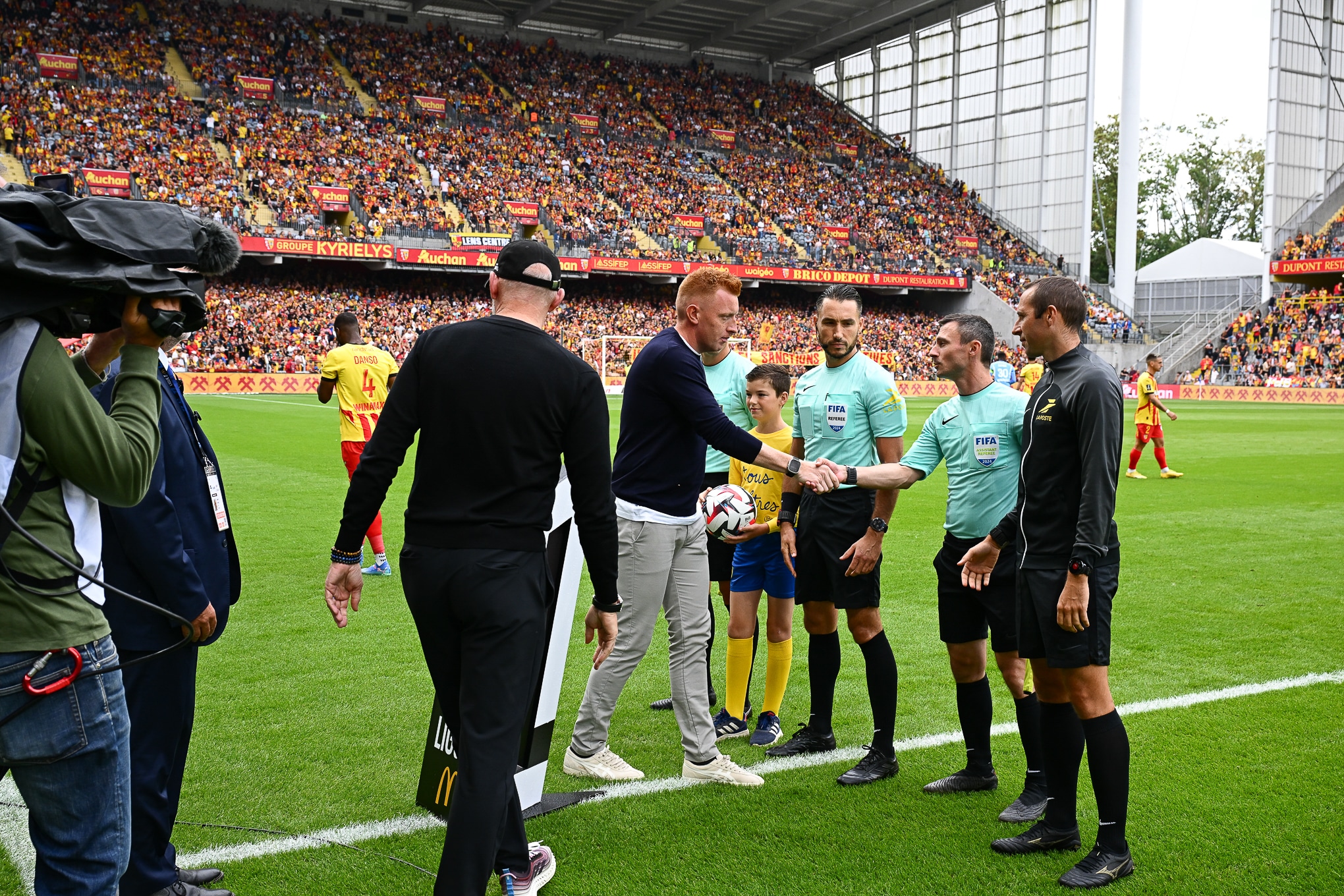 L'entraîneur du RC Lens, Will Still, saluant Jérémie Pignard et ses assistants avant un match à Bollaert.