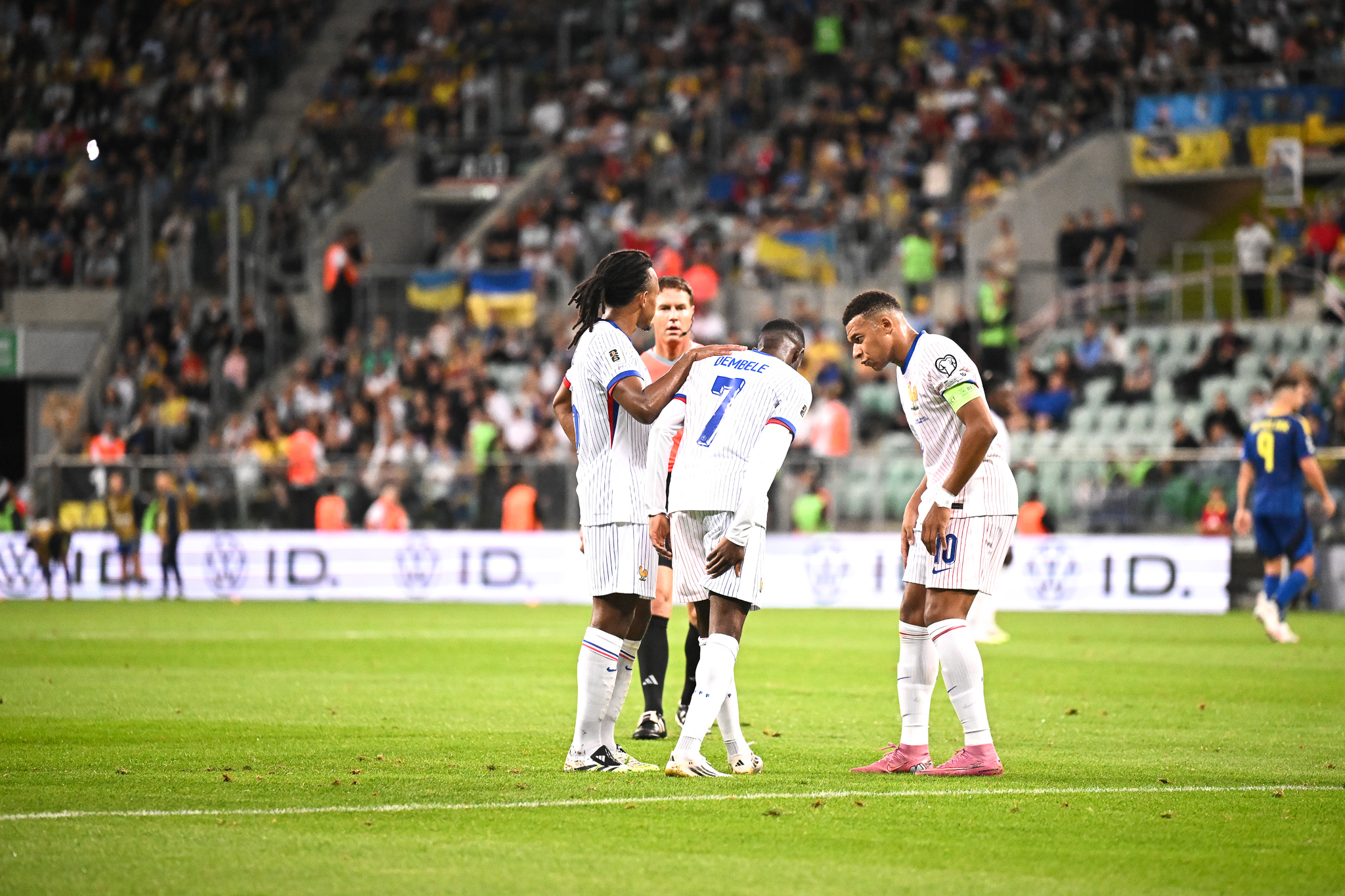 Ousmane Dembélé entouré de ses coéquipiers au moment de sa sortie lors d'Ukraine-France.